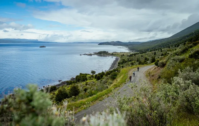 Cyclists riding along rocky path