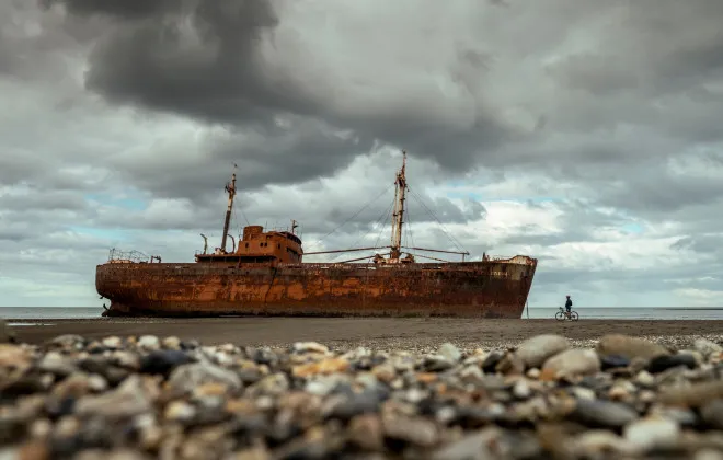 Cyclist stopping to look at shipwreck