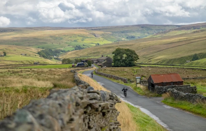 Cyclists riding along rural road
