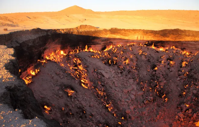 Crater in ground on fire