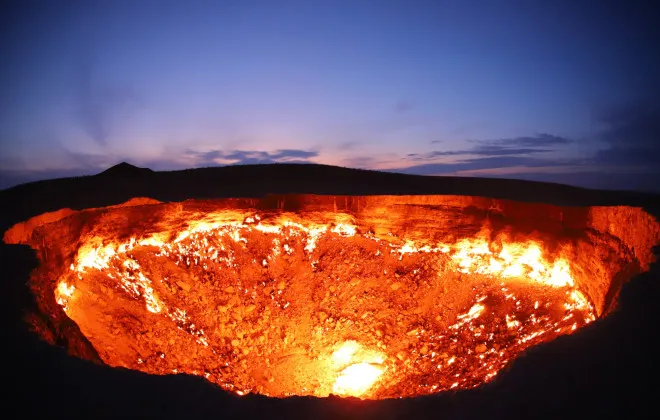 Crater in ground on fire