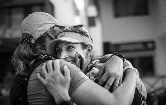 Two women hugging and smiling