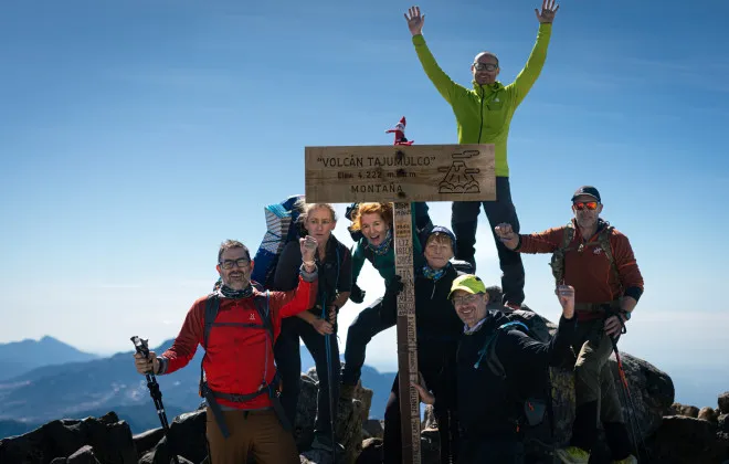Participants stood with volcano sign