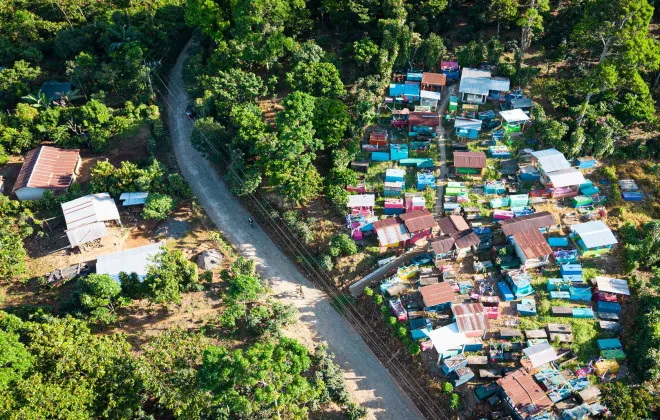 Road winding through greenery and houses