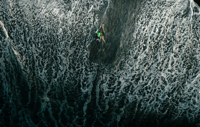 Aerial view man wading through water