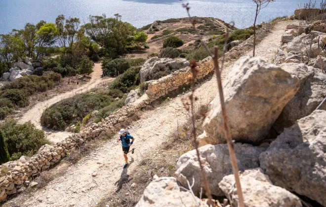 Participant running along dusty path in sunshine