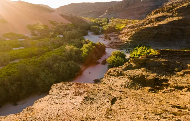 River travelling through greenery and rocky terrain