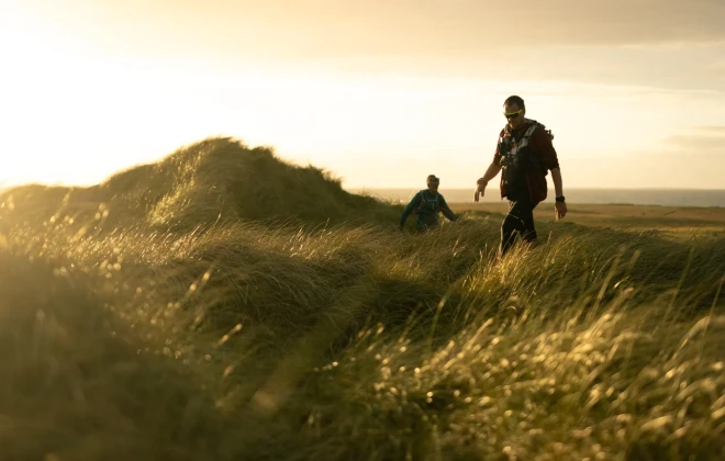People walking through long grass