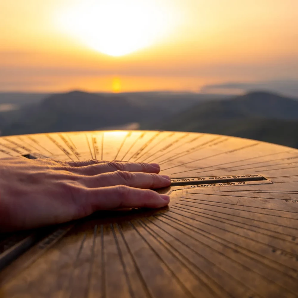 Participant touching the top of mountain at sunset