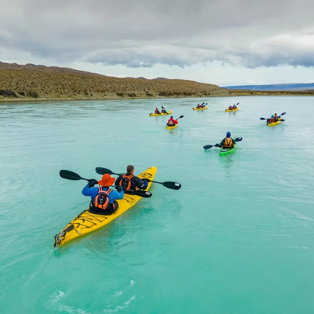 Participants kayaking through clear water