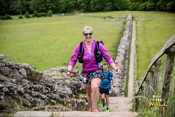 Woman smiling and walking up hill